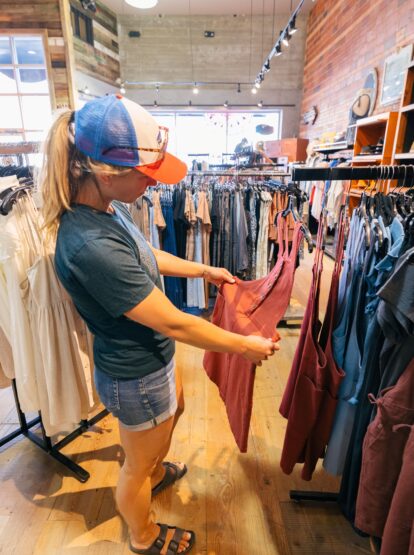 Person looking at seasonal clothing in a downtown Kalispell shop