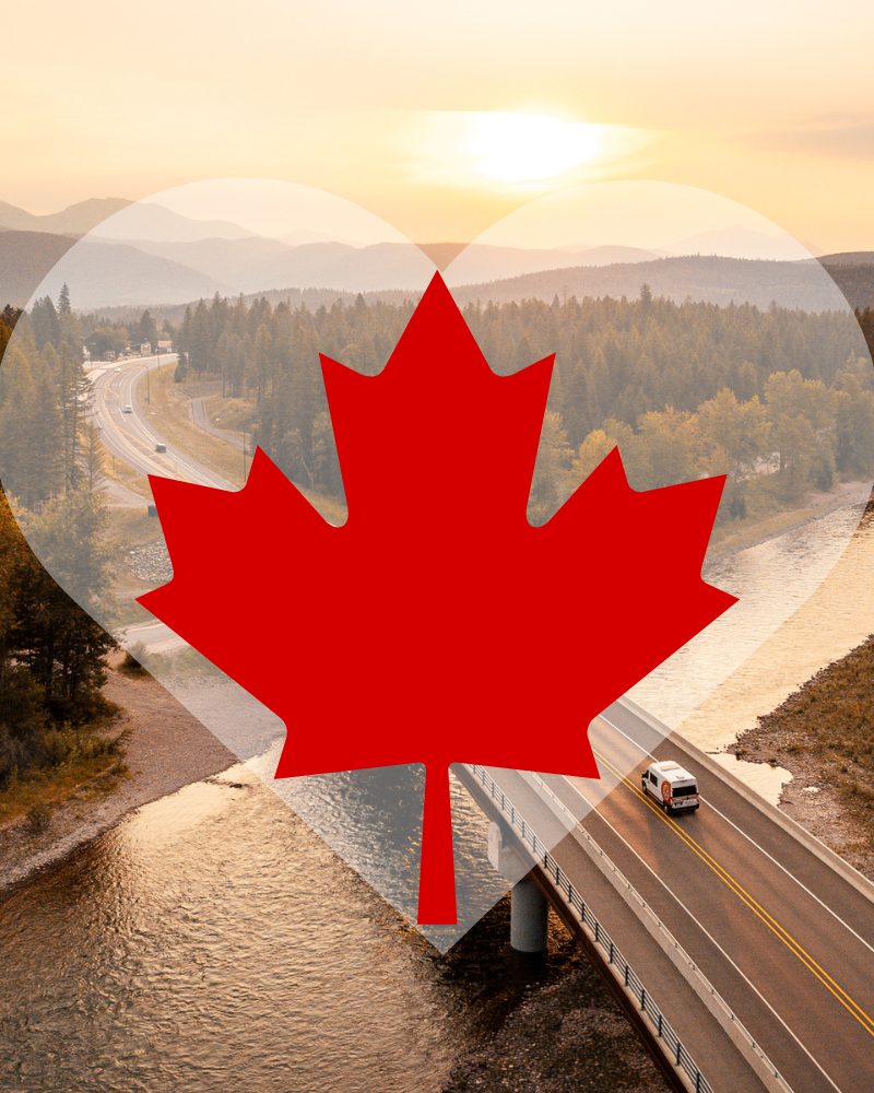 Aerial photo of road in to Flathead Valley with red leaf graphic on a transparent heart